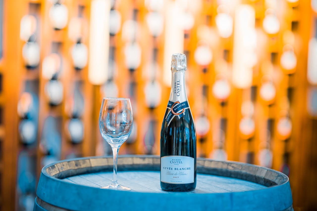 Champagne bottle and glass on a wooden barrel in a winery in Ethiopia, perfect for celebration themes.