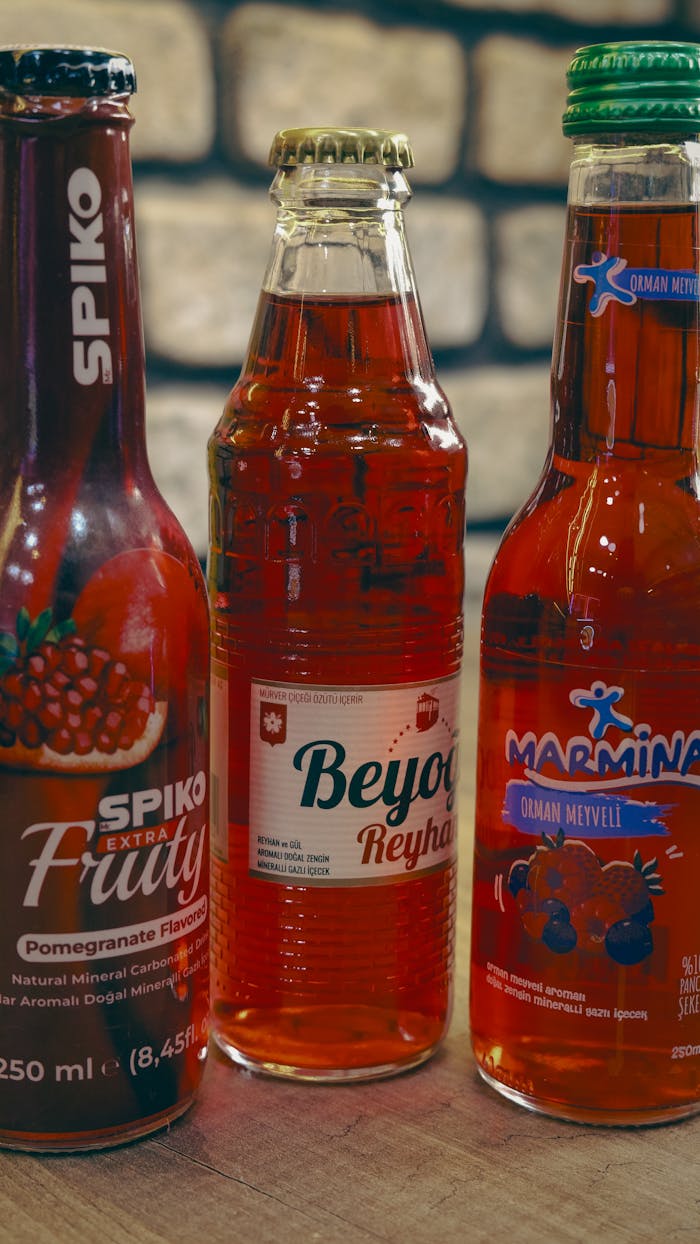 Close-up of three Turkish fruit soda bottles in Gaziantep market.